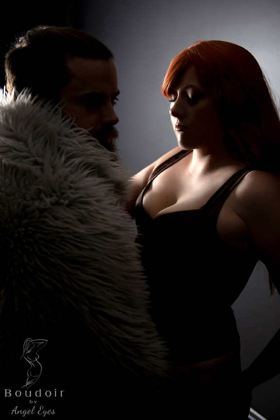 couple posing in dark studio