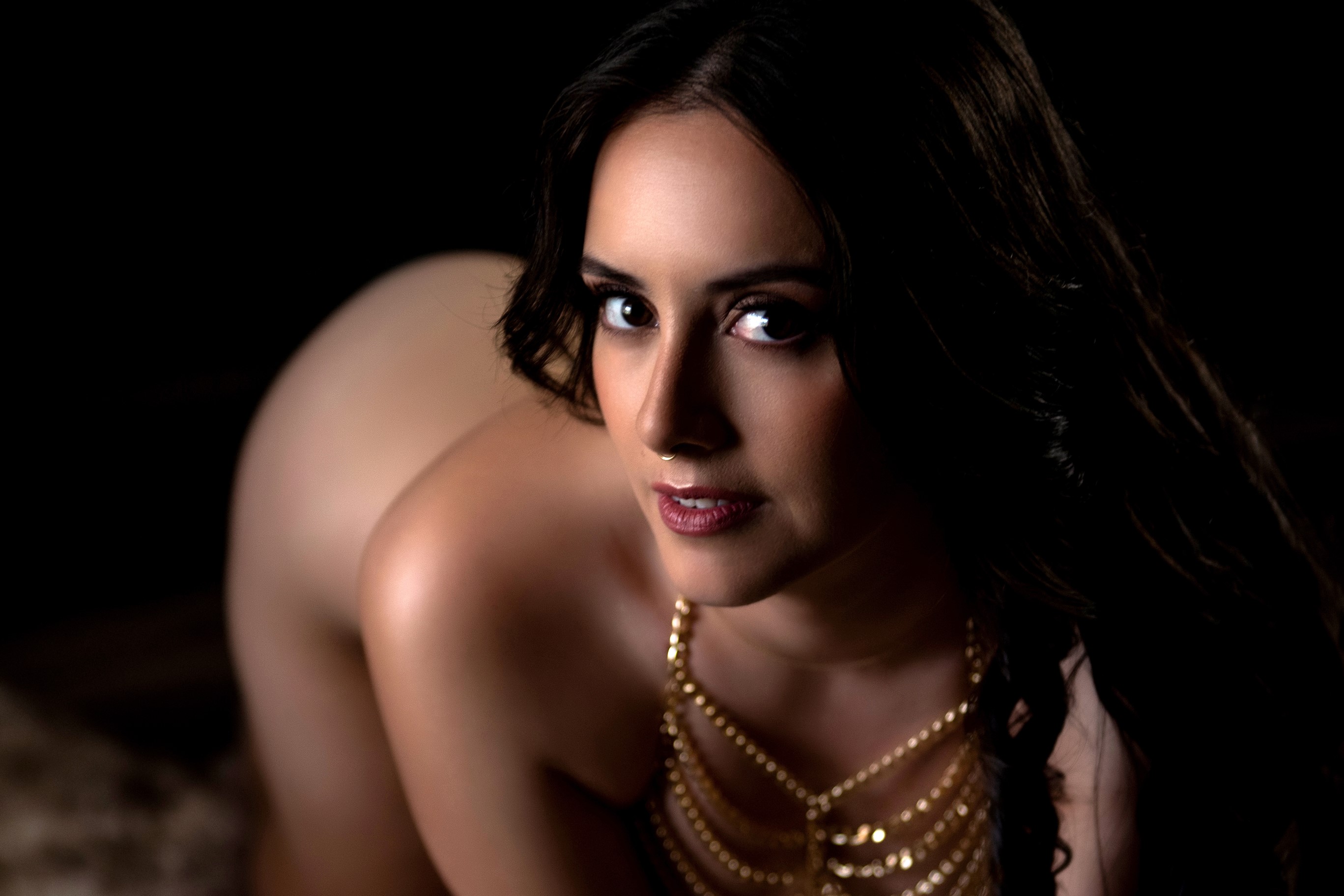 woman in wearing delicate gold jewelry